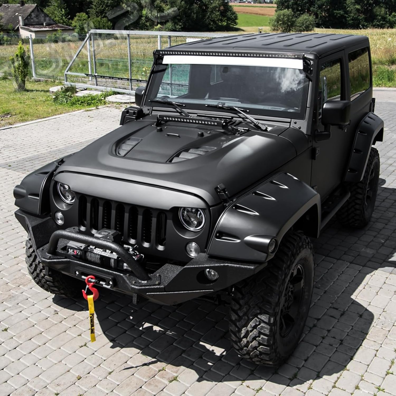 Vented hood installed on orange Jeep Wrangler JK