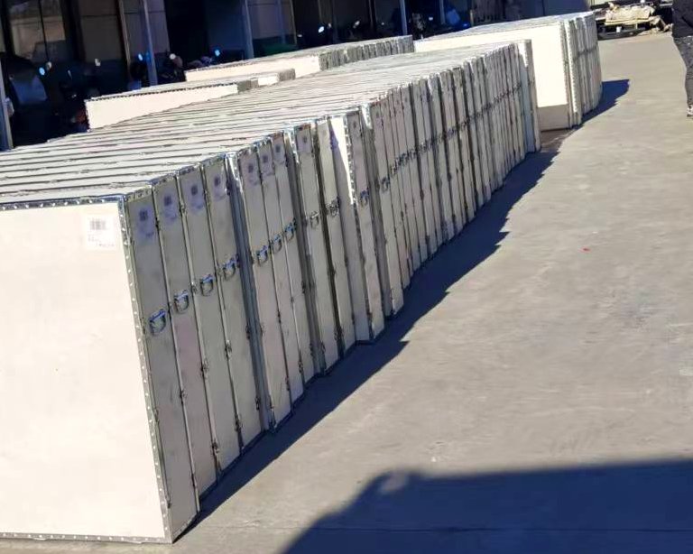Rows of wooden shipping crates for steel Jeep hoods staged at the warehouse